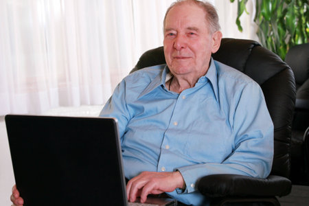 Elderly man using laptop computer