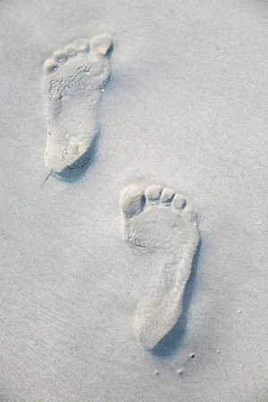 Set of footprints left in sandの写真素材