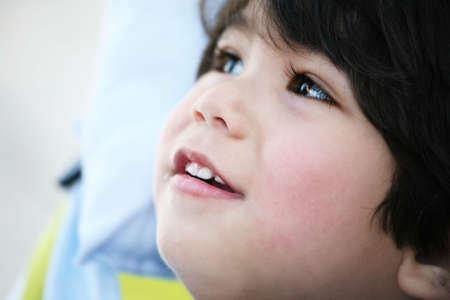 Handsome toddler boy profile,smiing and looking upの写真素材
