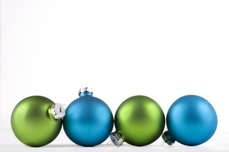 Blue and green Christmas ornaments lined up, isolatedの写真素材