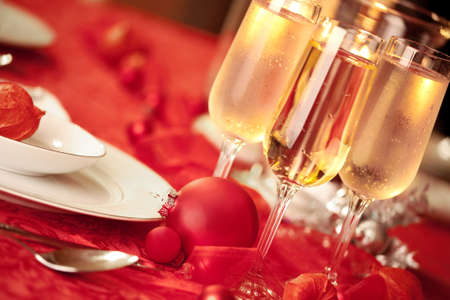 Elegant Christmas table setting in red with a Christmas ornament  as focal pointの写真素材