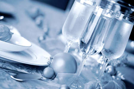 Elegant Christmas table setting in cool blue tones with a Christmas ornament  as focal pointの写真素材
