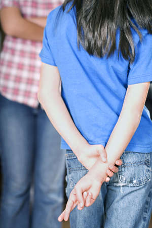 Girl crossing her fingersの写真素材