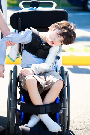 Young disabled child in wheelchair. Child has cerebral palsy.の写真素材