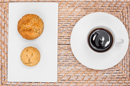 Vegan chocolate and coconut muffins and black coffee on a tableの写真素材
