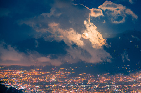 Moon behind the cloudsの写真素材