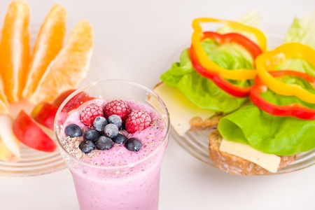 Drinkable yugurt and another food on the breakfast table.の写真素材