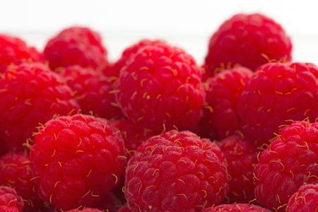 Many raspberries, white background.