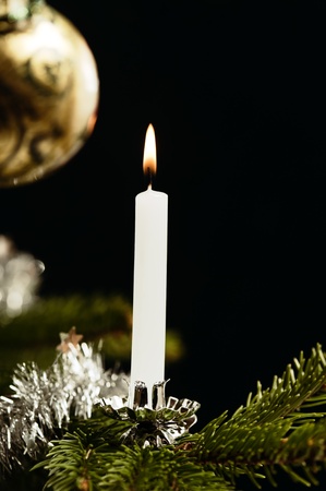 Traditional white candle on Christmas tree, retro look like の写真素材
