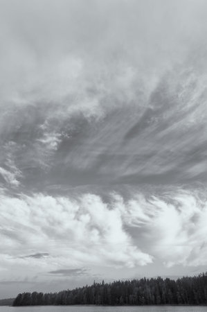 Dramatic clouds on the sky, colored black and white image 