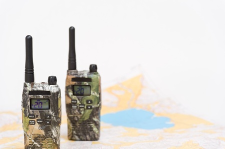 Two walkie-talkies and map on the background.の写真素材