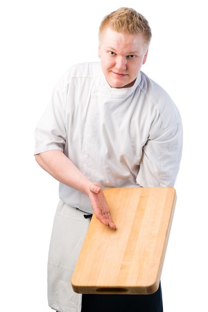 Young cook demonstrate something on chopping boardの写真素材