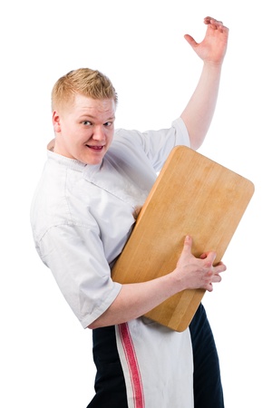 Young cook playing air guitar with a chopping boardの写真素材