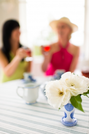 The women have a good time together, the narrow focus on front of flower vaseの写真素材