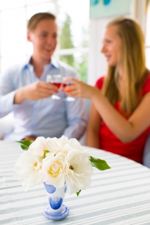 Young couple have a good time together, the narrow focus on front of flower vaseの写真素材
