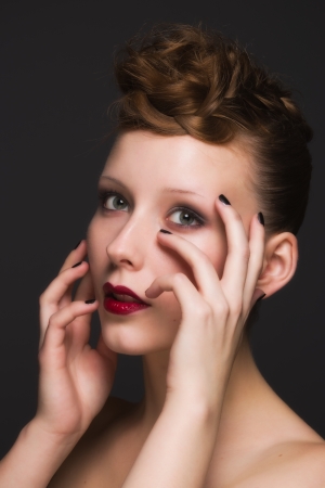 Beautiful young model with bright make-up and manicureの写真素材