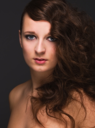 Portrait of pretty girl on dark backgroundの写真素材