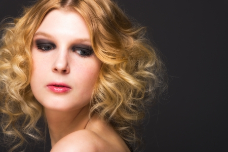 Portrait of pretty girl on dark background, horizon formatの写真素材