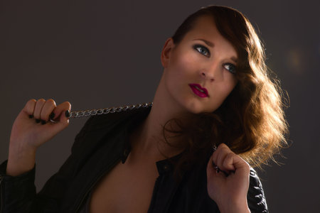 Portrait of attractive pretty girl on dark backgroundの写真素材