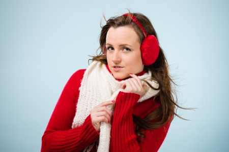 Beautiful young woman wearing a ear muffs and white scarf, horizon formatの写真素材