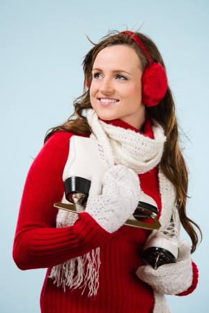 Beautiful skater wearing a ear muffs and white scarf, vertical formatの写真素材
