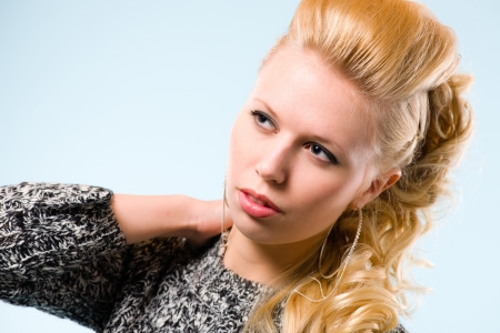 Portrait of young beautiful girl, blue background, horizon formatの写真素材