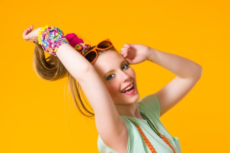 Happy girl with colorful clothes, yellow backgroundの写真素材