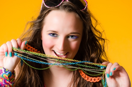 Close-up of beautiful girl and necklace, make-up, yellow backgroundの写真素材