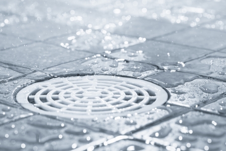 Floor drain, running water in shower, tinted black and white imageの写真素材