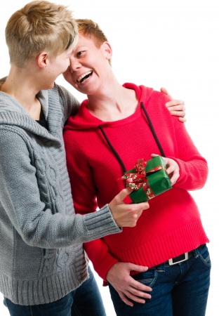 Lovely lesbian couple and christmas gift, waist up image with white backgroundの写真素材