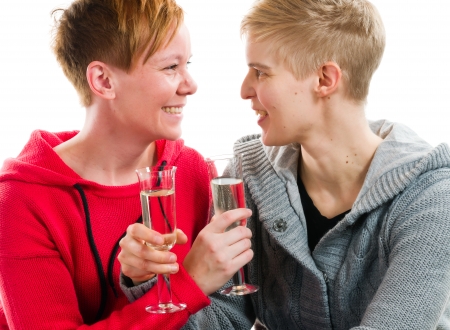 Lesbian couple and sparkling wine, white background and horizon formatの写真素材