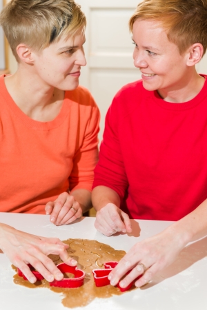 Lovely lesbian couple makes gingerbread in the kitchenの写真素材