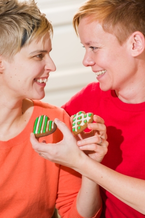 Lovely lesbian couple together and decorated gingerbreadの写真素材