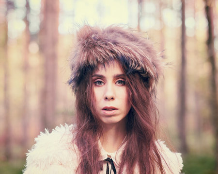 Fashionable beautiful woman in the forest - warm tinted image