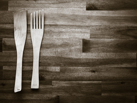 Wooden fork and spatula on the table - tinted black and white imageの写真素材
