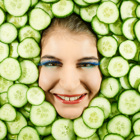 Beautiful woman expression face with cucumber slice frameの写真素材