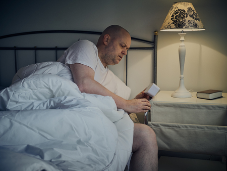 Middle aged man wakes up in the morningの写真素材