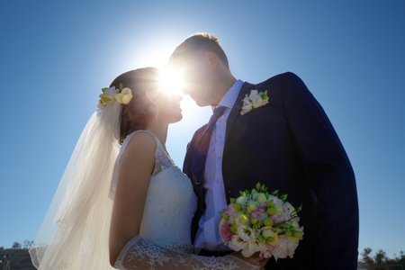 Young bride and groom walk in nature on the wedding dayの写真素材