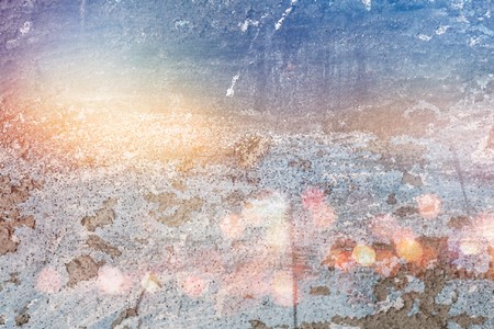 Fading dark texture background with bright light and glare, bokehの写真素材