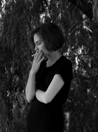 Outdoor portrait of a sad teenage girl looking thoughtful about the problems, the concept of sadness, lonelinessの写真素材