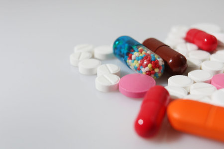 Colorful pills closeup on white background, concept of health and medicine