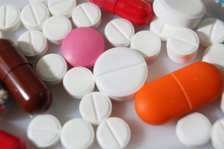 Colorful pills closeup on white background, concept of health and medicine