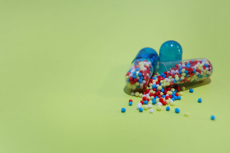 Colorful pills closeup on a green background, the concept of health and medicine
