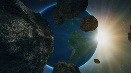 asteroid or meteorite flies in space, on the background of the planet earthの写真素材