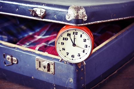 Old suitcase with old alarm clock and old shirtの写真素材