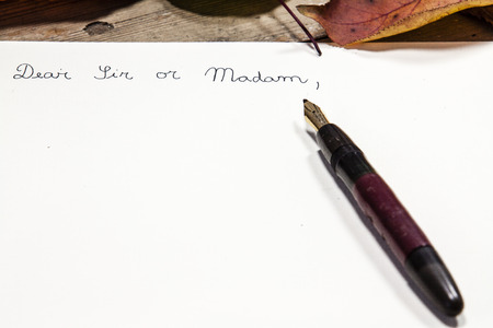 Old fashioned letter with a pen and leafsの写真素材