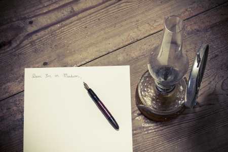 Old fashioned letter with a pen and lampの写真素材