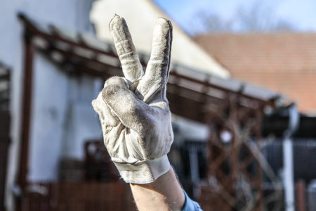 mans hand in grey dirty gloveの写真素材