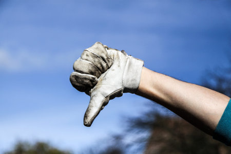 mans hand in grey dirty glove