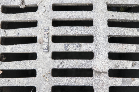 grid covering old canalisation in townの写真素材